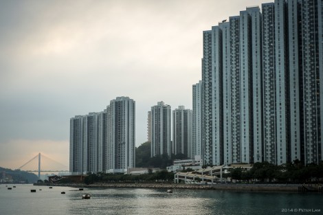 The apartments tower over the shore. Tin Kau Bridge in the distance.